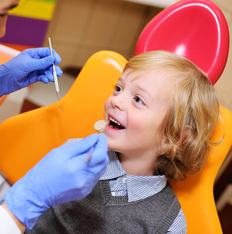 young boy having his teeth examined at the dentist's office