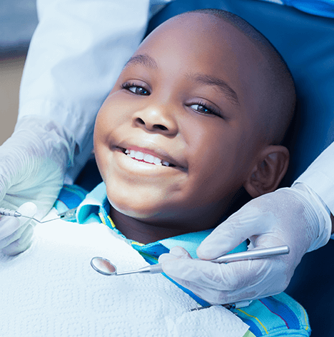 boy getting his teeth examined